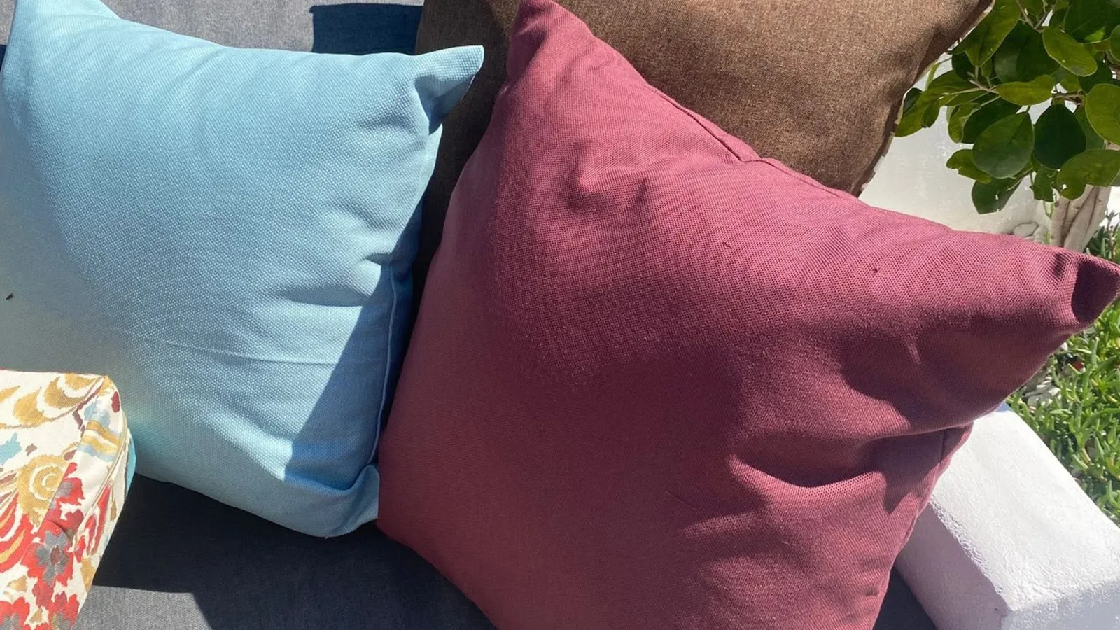 Brightly coloured outdoor cushions in full Costa Blanca sunshine