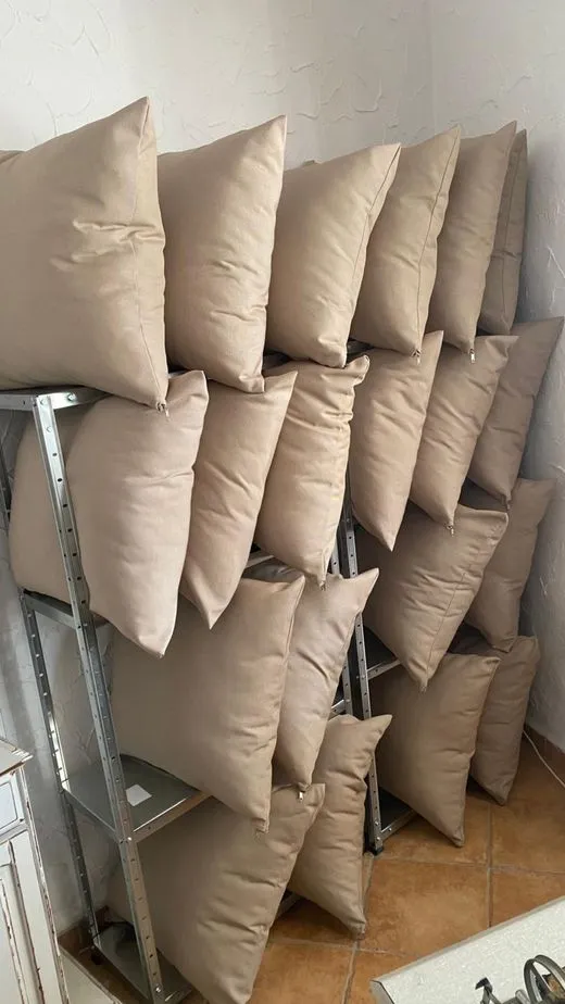 Handmade cushion inserts stacked in Cindy's workshop