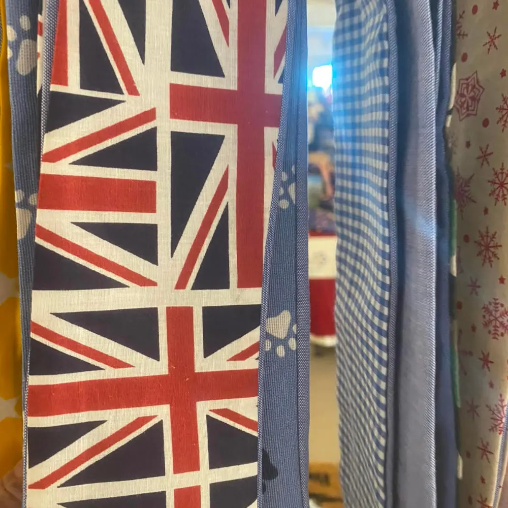 Union Jack and paw print dog bandana fabrics in the workshop