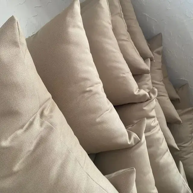 Stack of custom-made cushion covers in natural coastal tones
