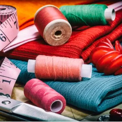 Threads, fabrics and tools at the sewing table